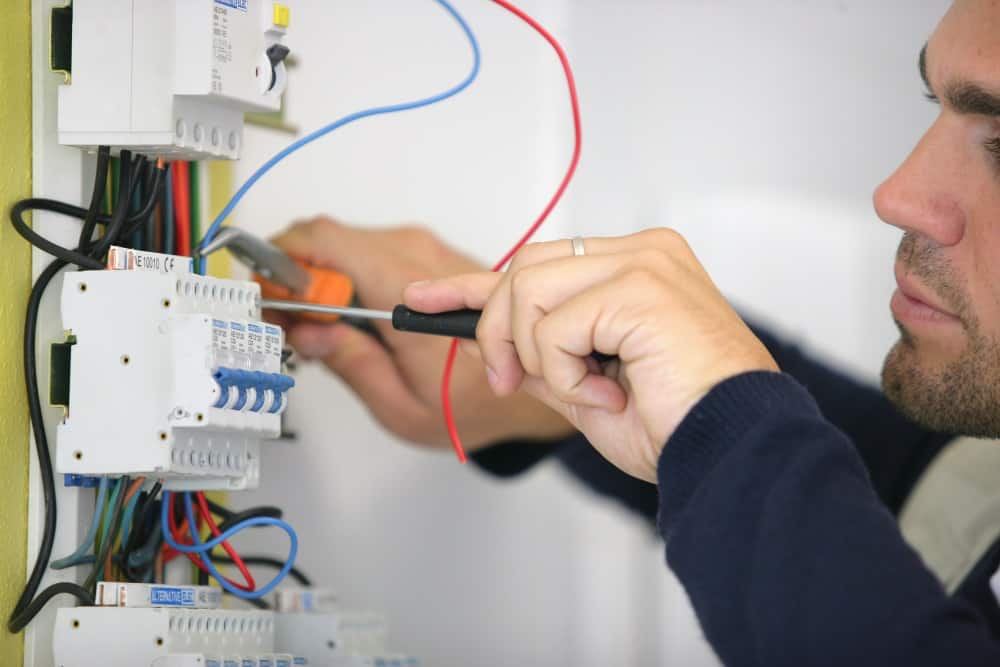 electrician working on circuit breaker